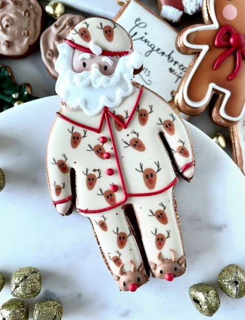 Pierniczek lukrowany Mikołaj w piżamie w renifery Pierniczek lukrowany Mikołaj w piżamie w renifery